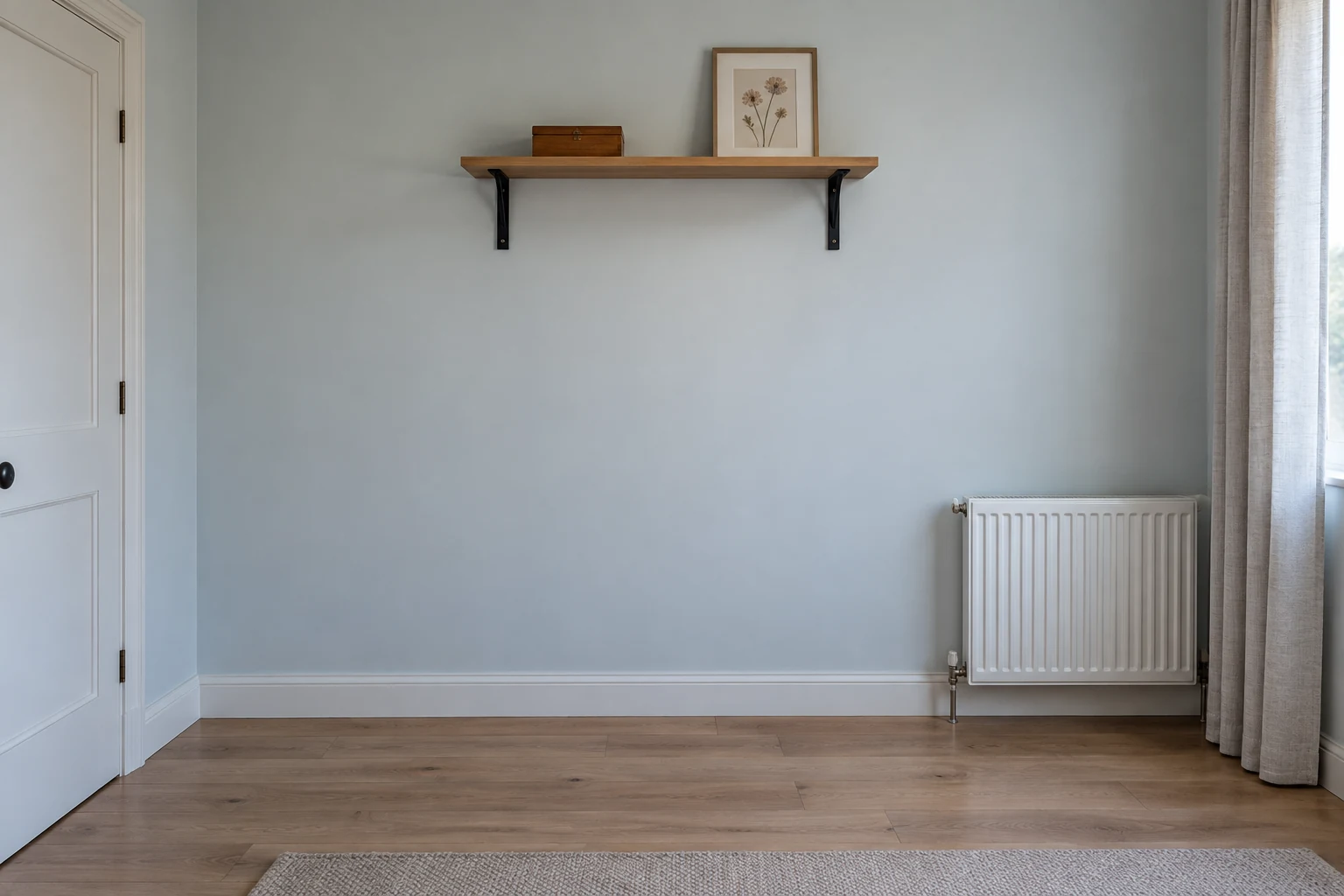 High wall shelf with open floor below and clear space from a curtain and radiator.