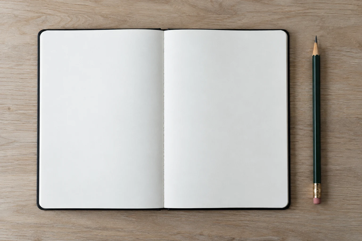 An open blank notebook with a pencil beside it.