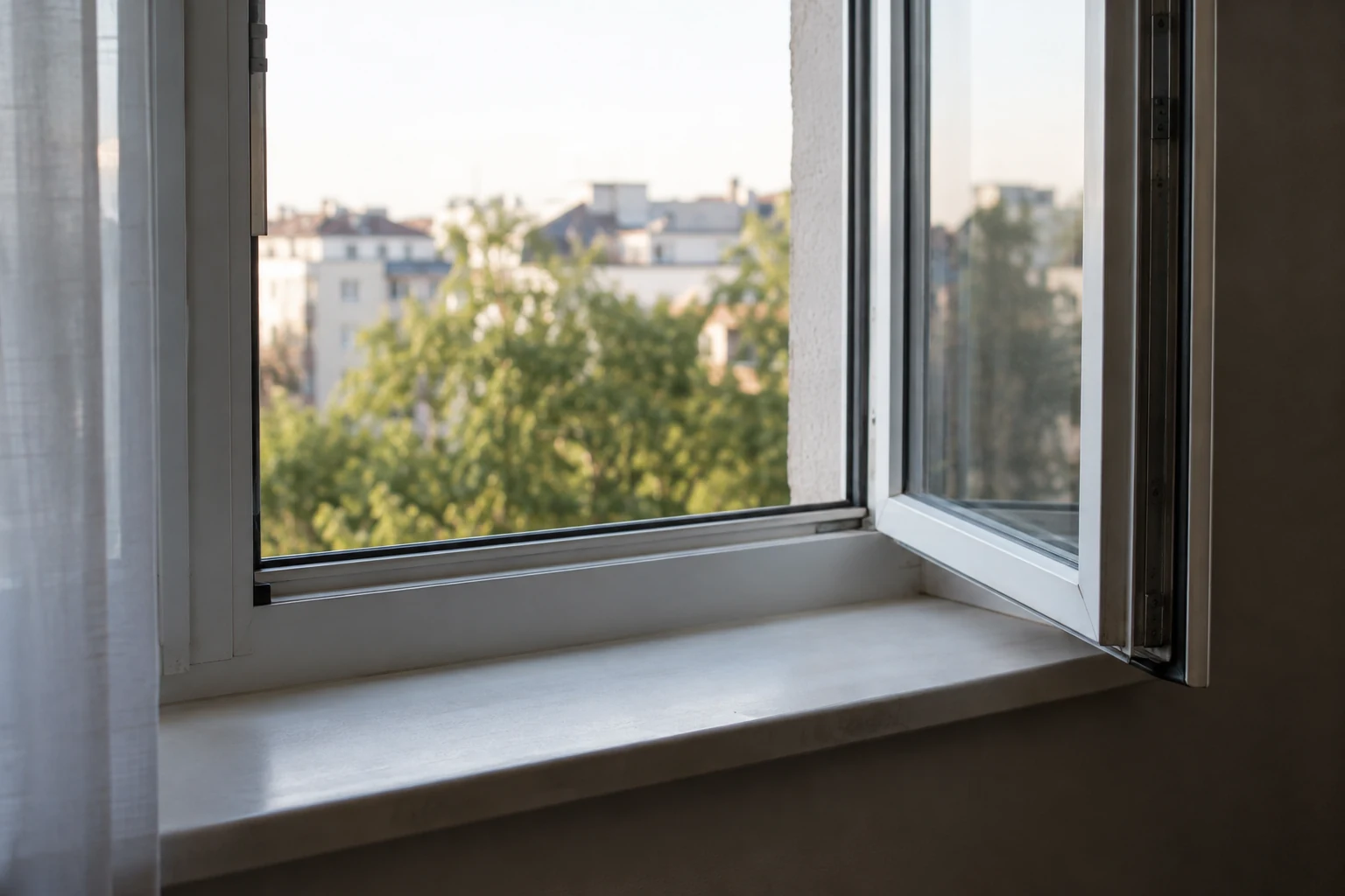 Open home window above an empty ledge.