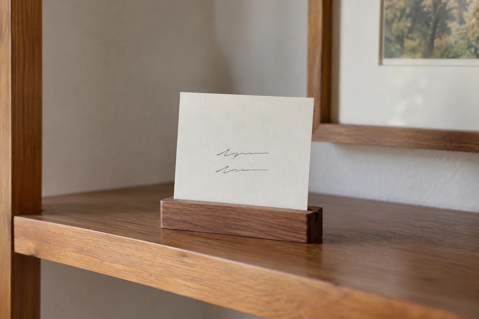 A simple handwritten remembrance card standing in a wooden holder on a shelf.